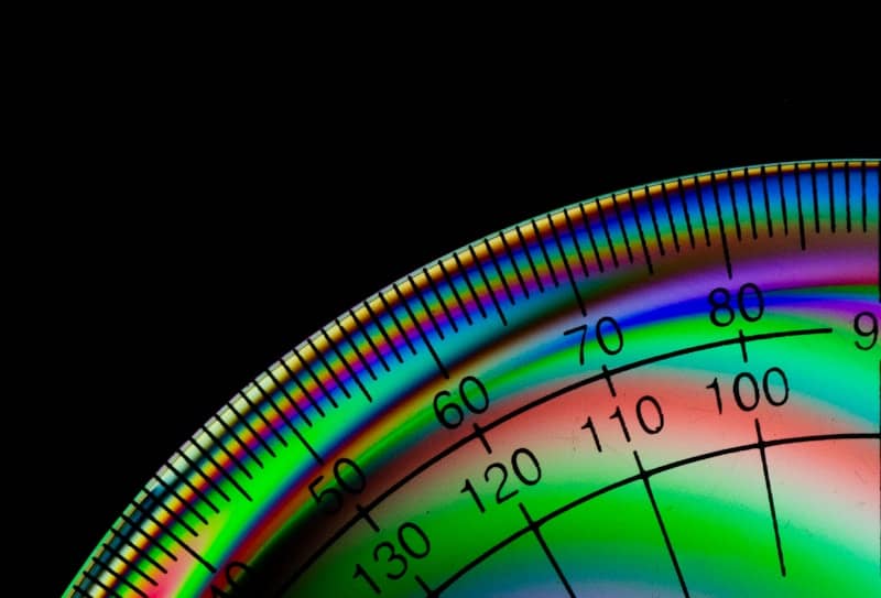 Close-up of a protractor with colorful interference patterns.