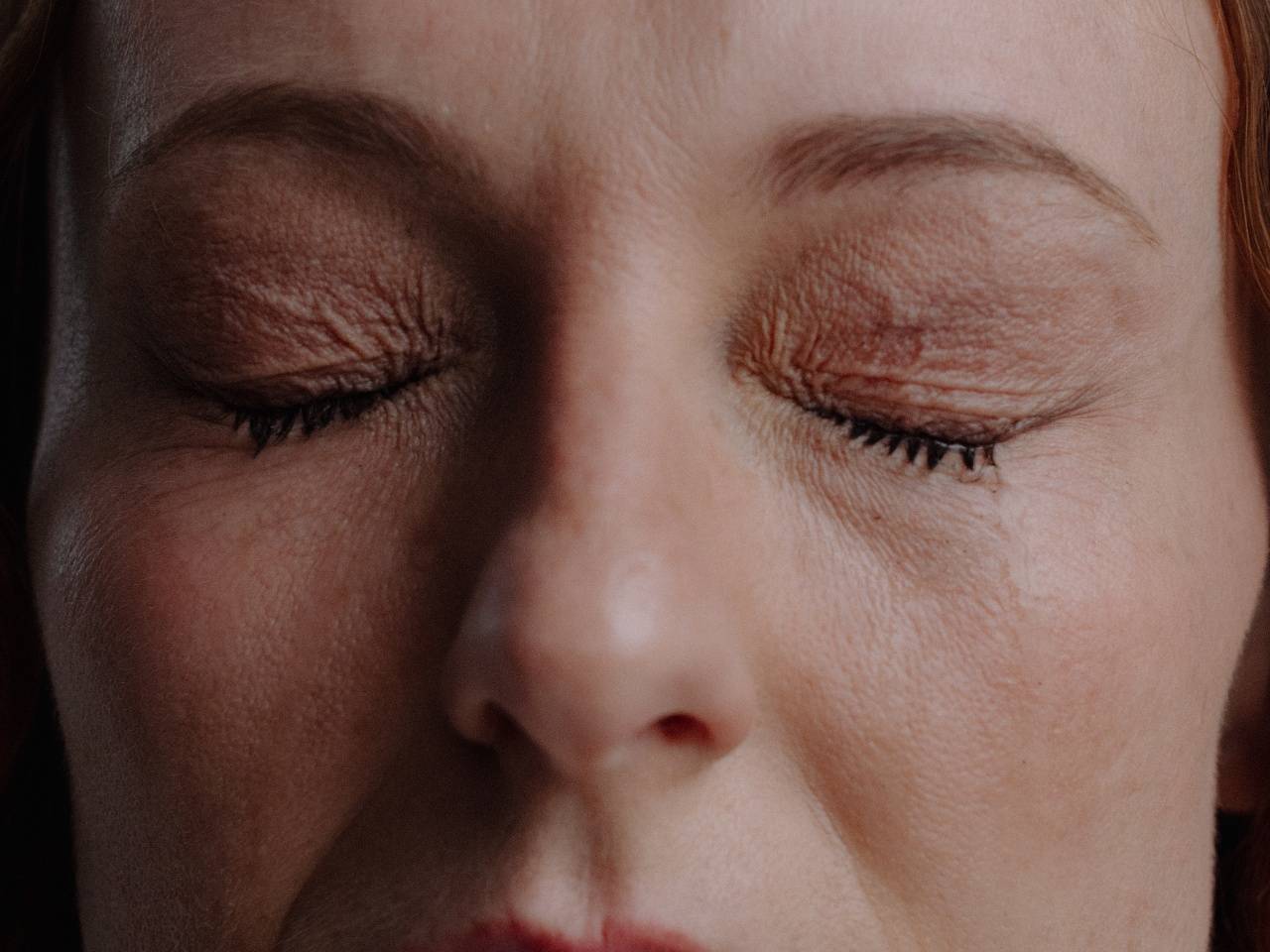 Woman with eyes squeezed shut