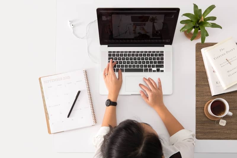 laptop on brown wooden table