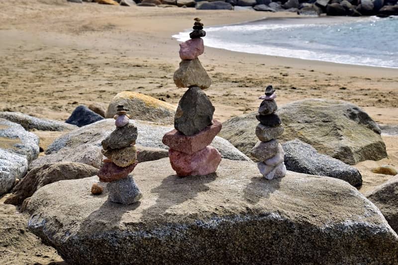 Stacked rocks on a sandy beach near the ocean