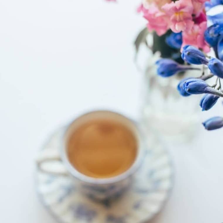 Flowers and tea create a lovely, elegant scene.