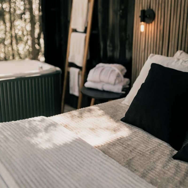 A bedroom with a bed and a bathtub in it