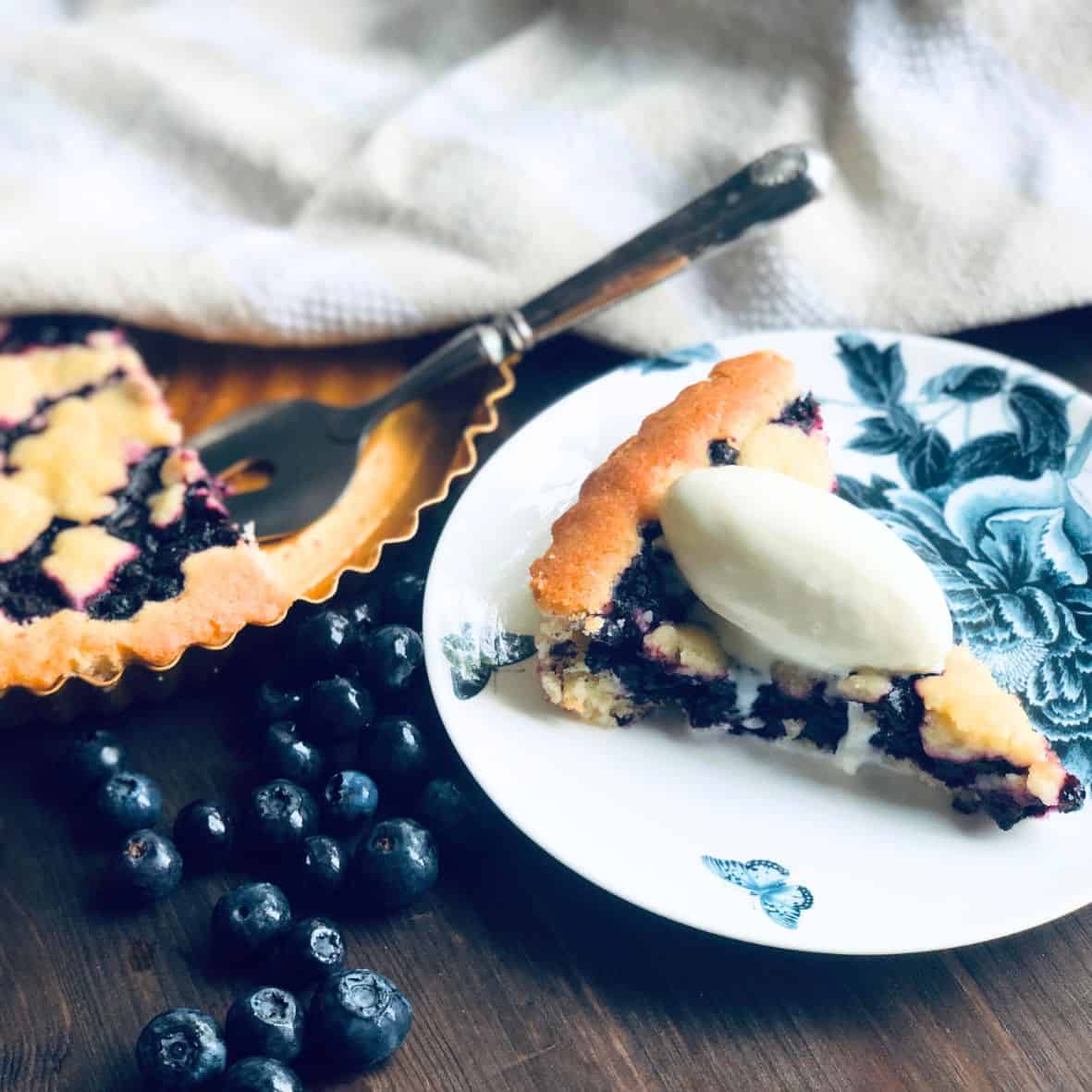 A blueberry pie with vanilla ice cream