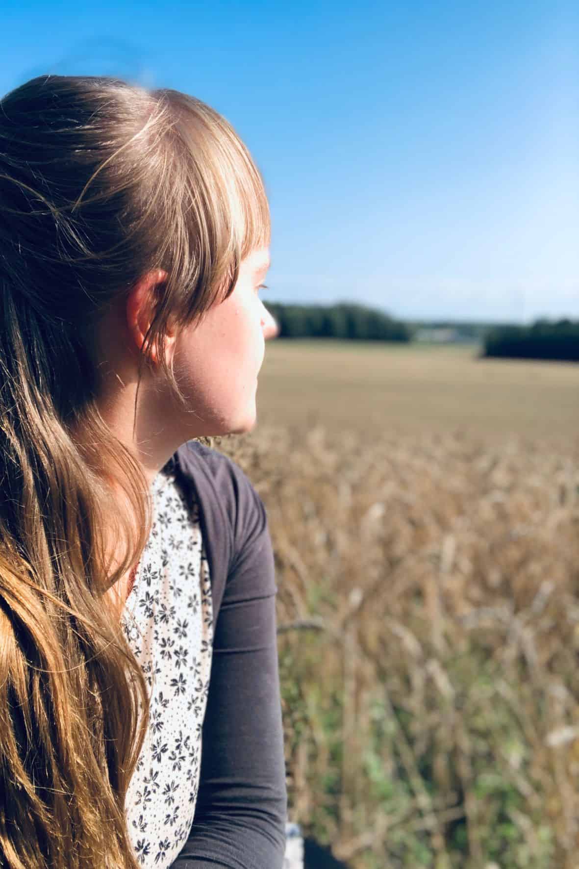 A woman gazing over the Autumn fields