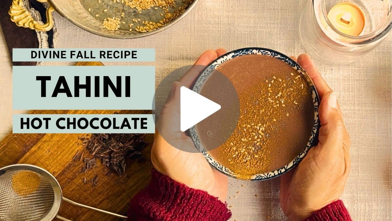 A woman holding a thing hot chocolate mug in a YouTube thumbnail
