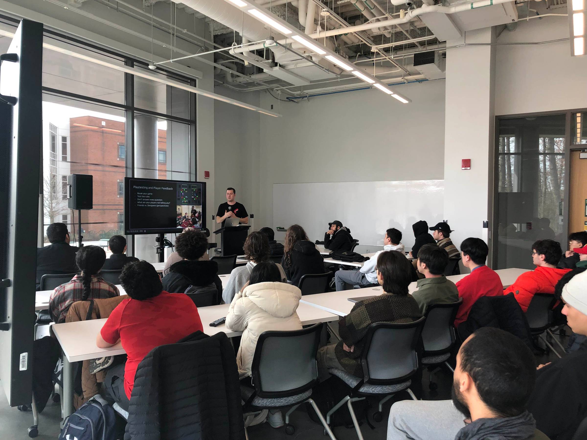 Image of Luke presenting in front of students