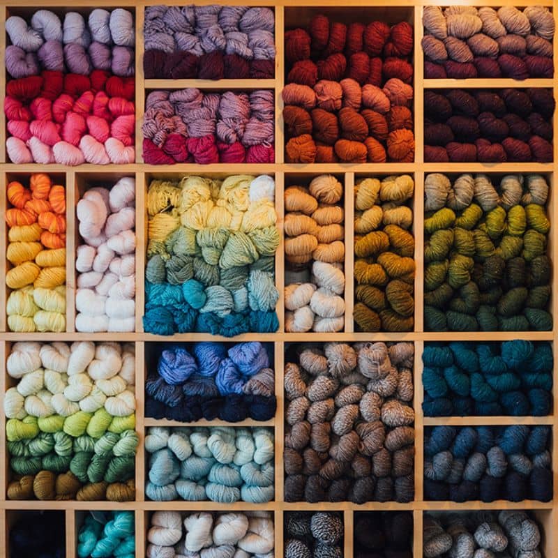 stacked yarn shelves fill of colorful yarn