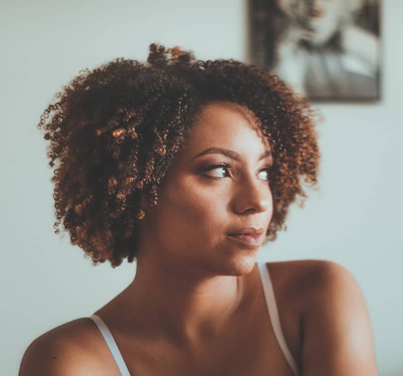 Black woman looking off to the side thinking
