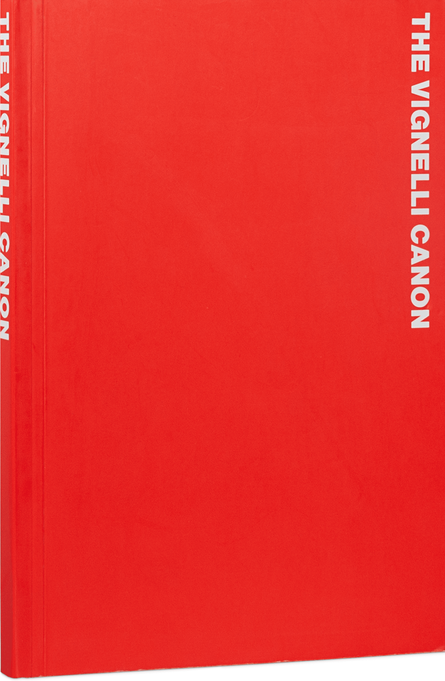 Red paperback book, standing upright, titled 'The Vignelli Canon' in the top right in capital off-white bold letters written sideways from up to down