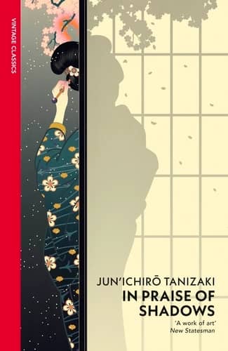 Cover of "In Praise of Shadows" by Jun'ichirō Tanizaki, Vintage Classics edition. A Japanese woman in a dark floral kimono reaches toward cherry blossoms, her silhouette cast against shoji screen panels. A New Statesman quote reads "A work of art."