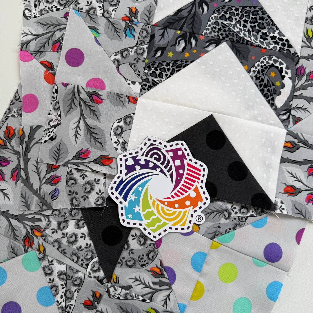 Quilt Blocks made with Tula Pink's Graywork fabric and a Cotton Cuts rainbow sticker on top