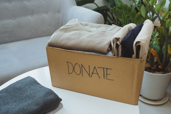 box filled with clothes that says donate