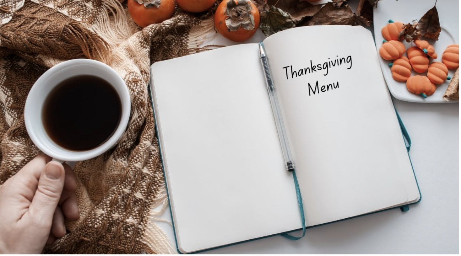 notebook that says thanksgiving menu with person holding coffee cup