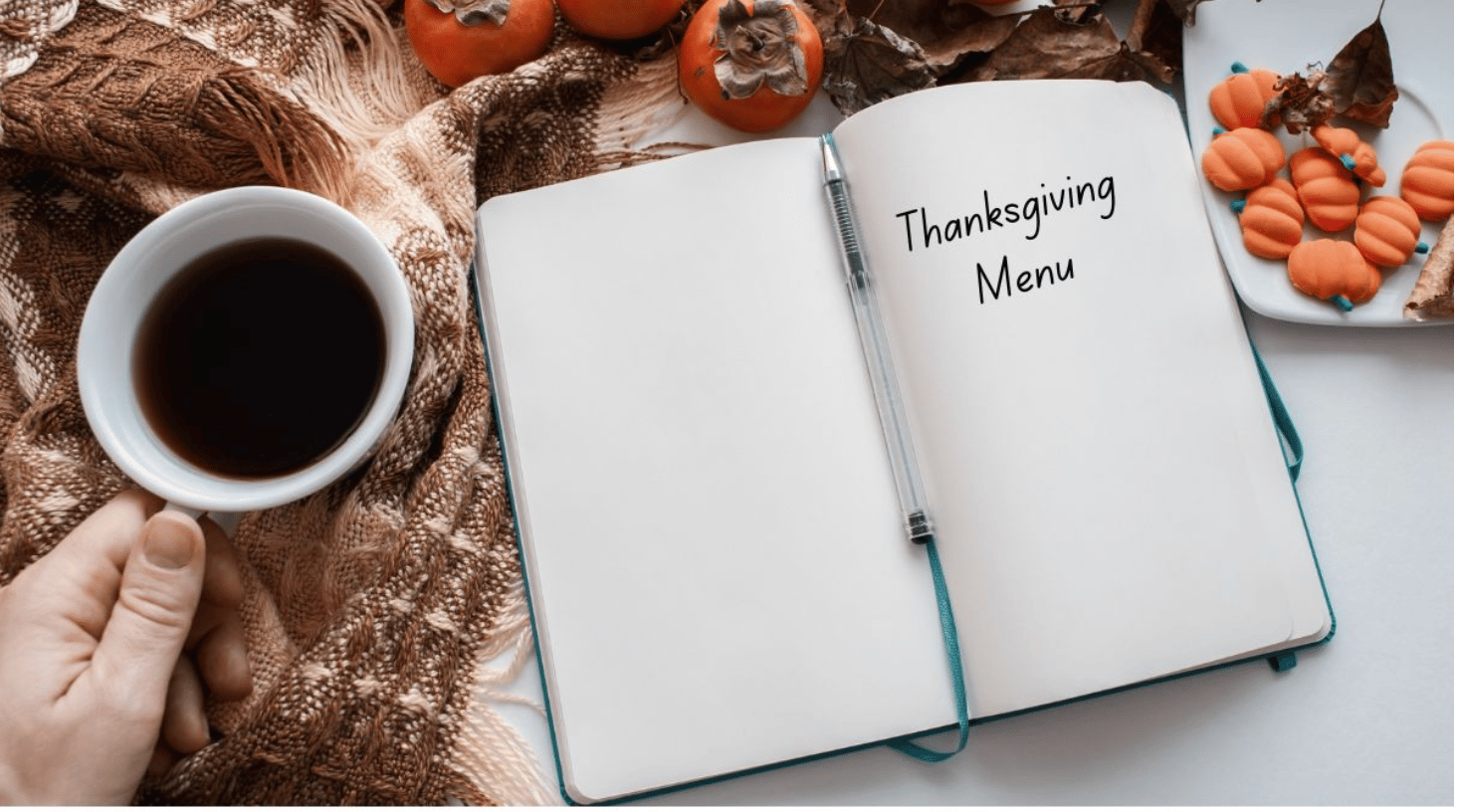 notebook that says thanksgiving menu with person holding coffee cup