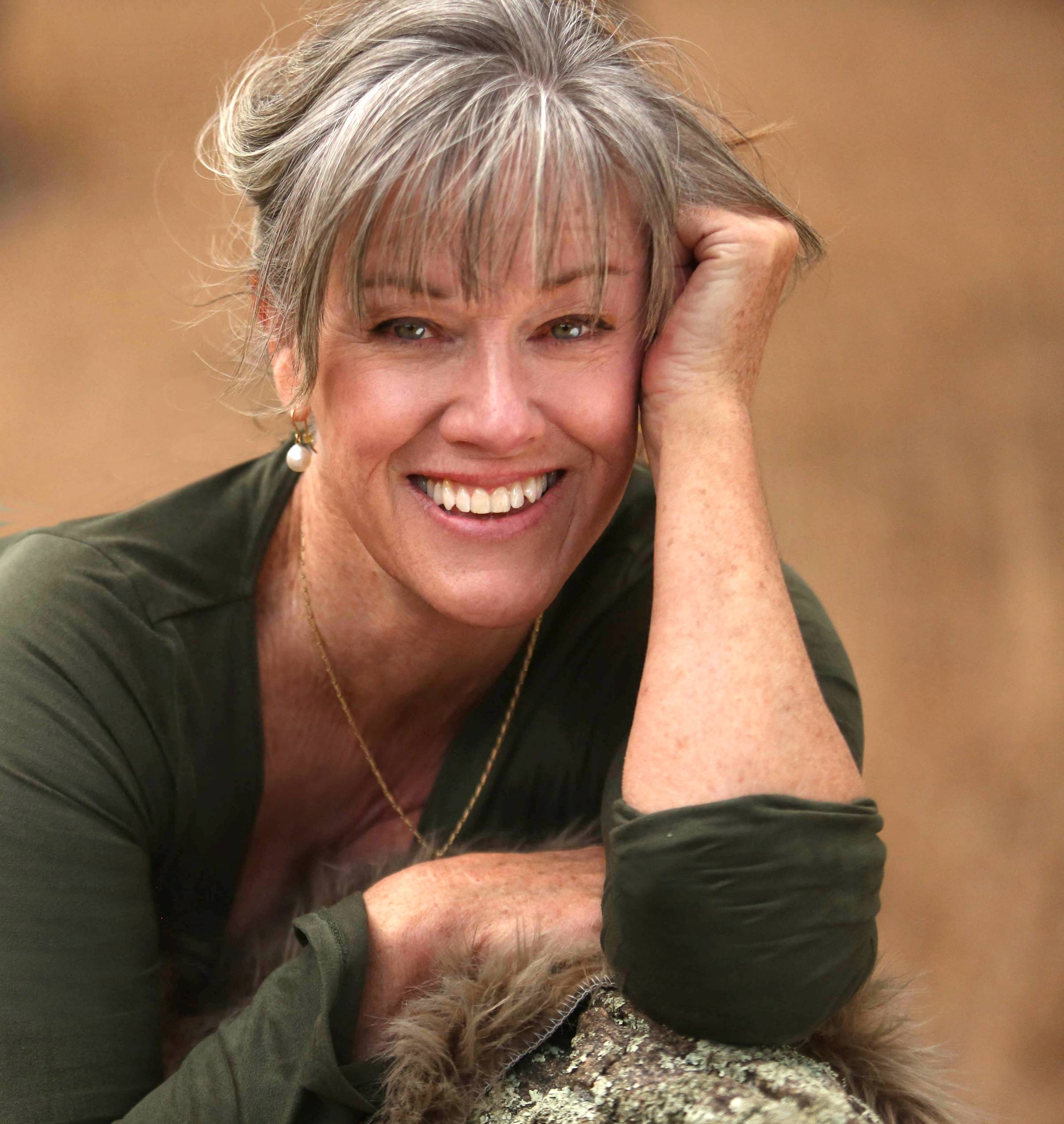 Anne smiling, on rock