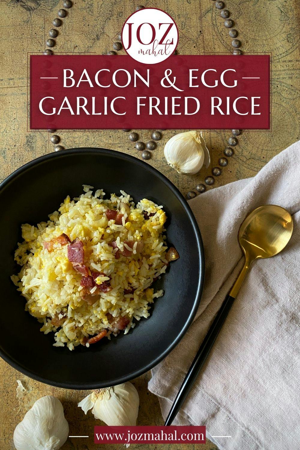 Bacon and garlic fried rice in a black bowl.