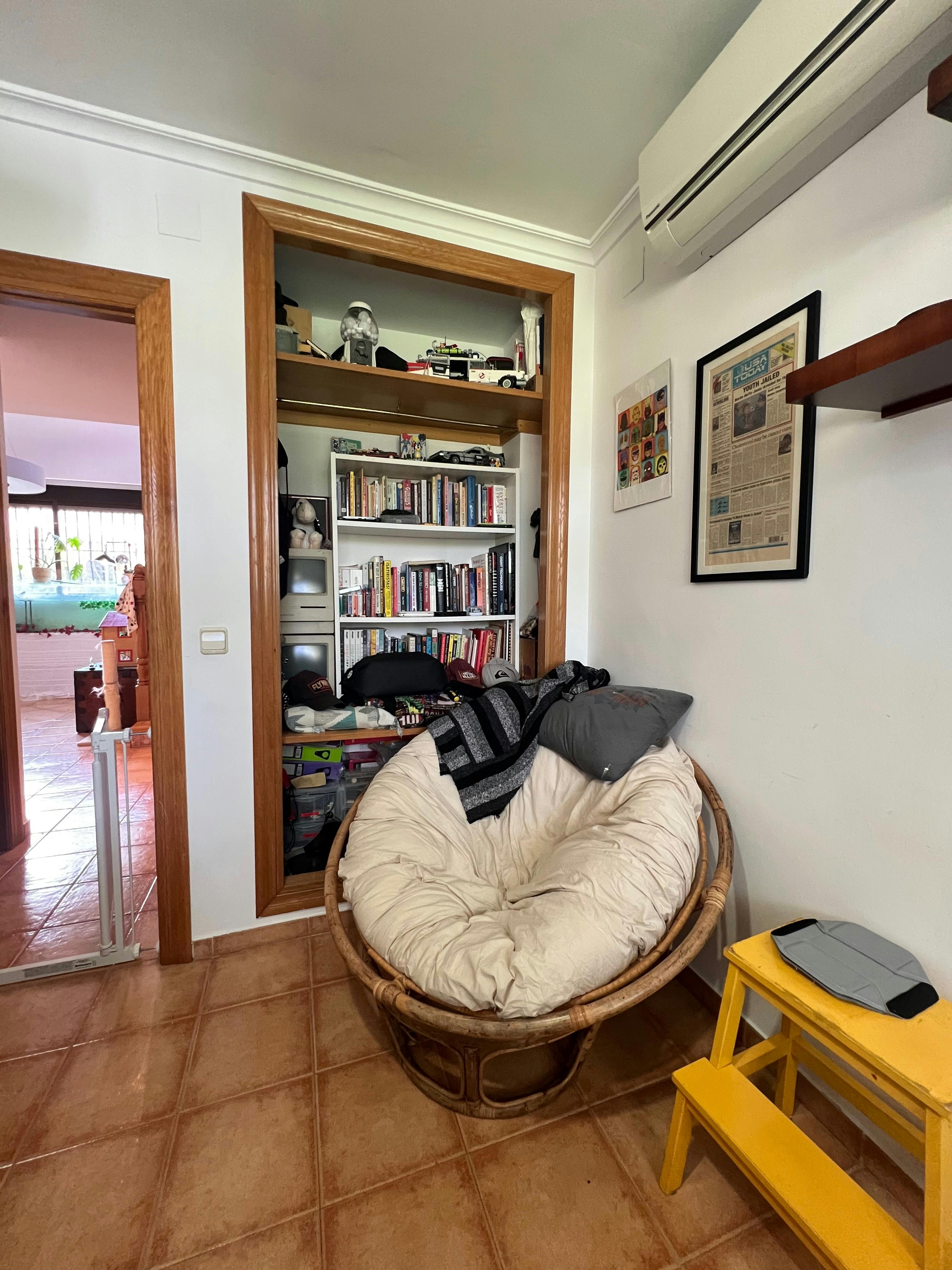 Interior picture of an office with a papasan chair in the corner.