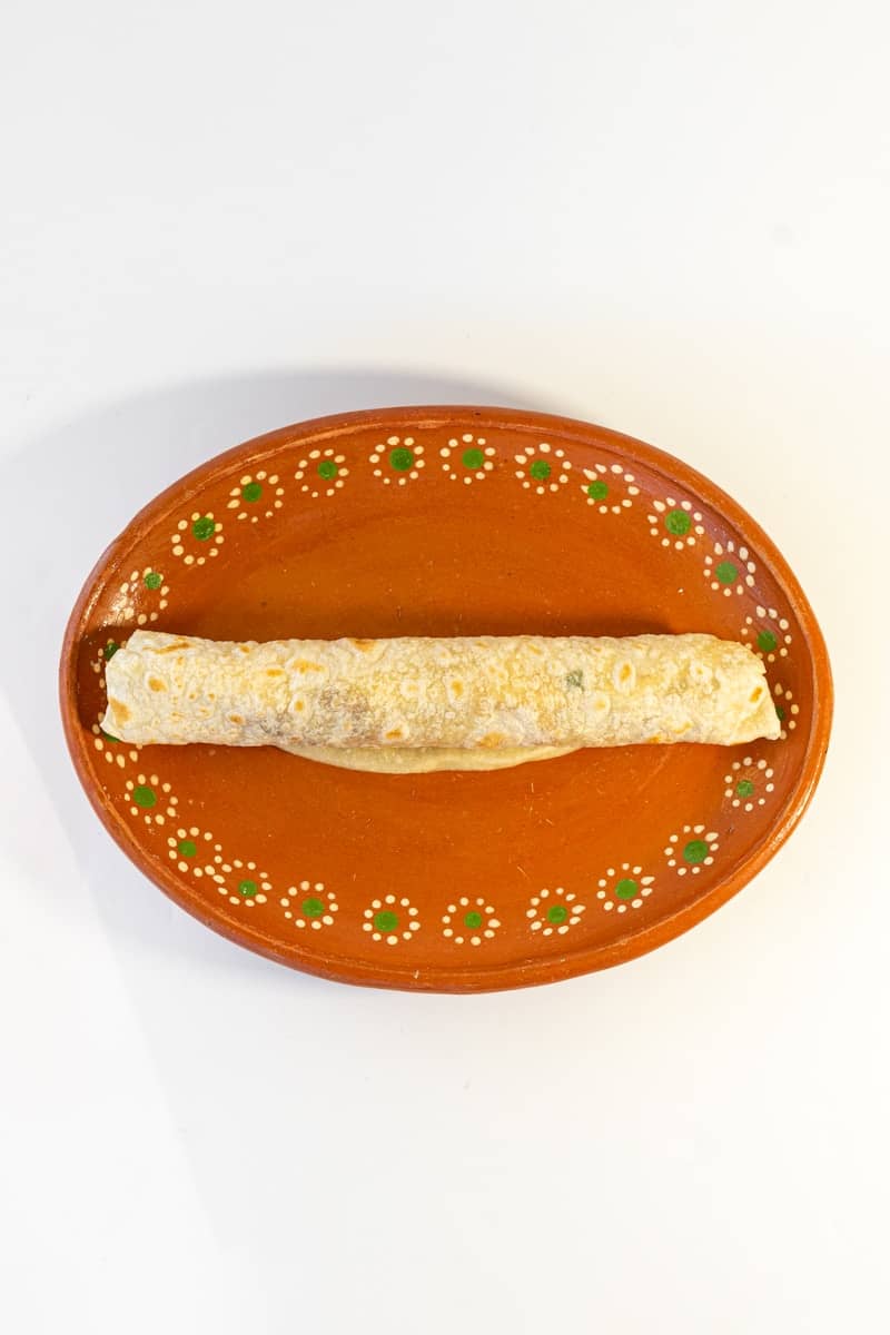 A piece of food on a plate on a table