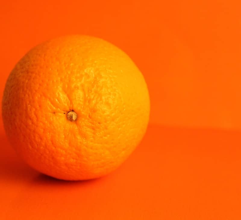 An orange on an orange background.