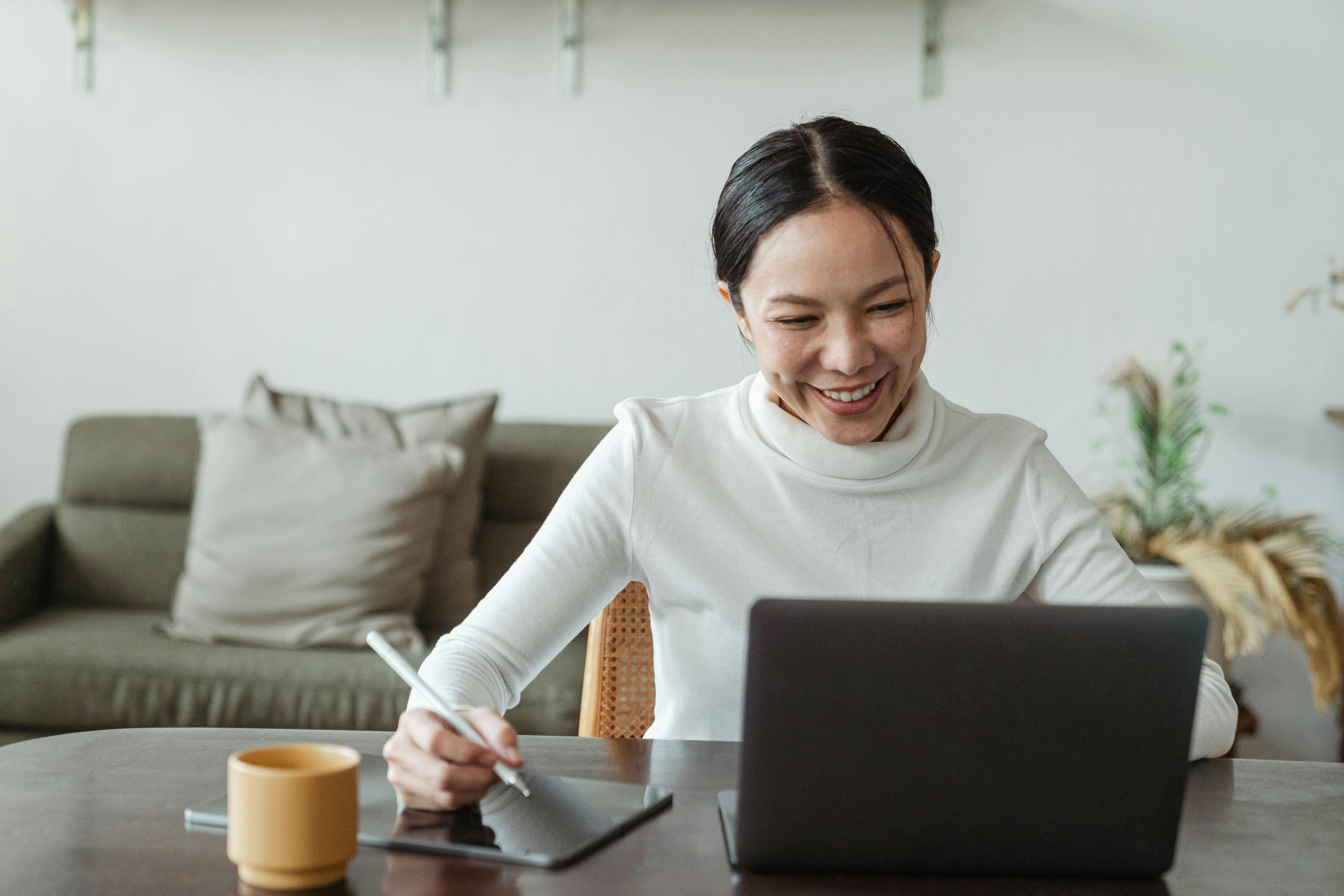 Smiling Asian businesswoman working at women and making a video call.