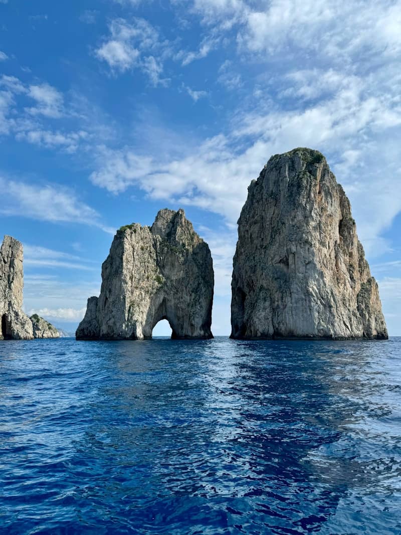 A large rock formation in the middle of the ocean