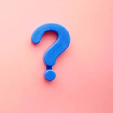 a blue question mark on a pink background