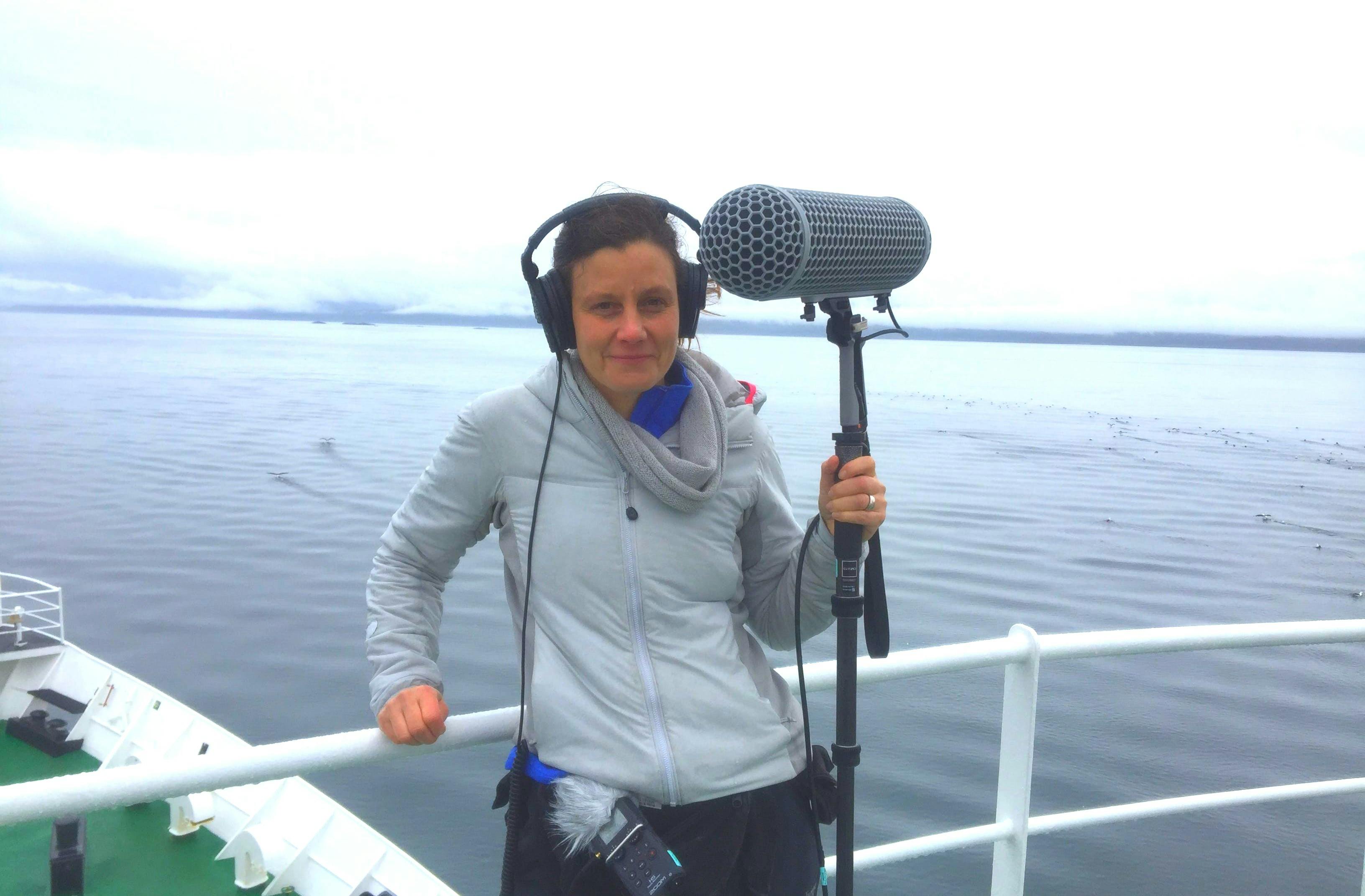 Photo of author Samantha Hodder in Antarctica, holding her giant microphone