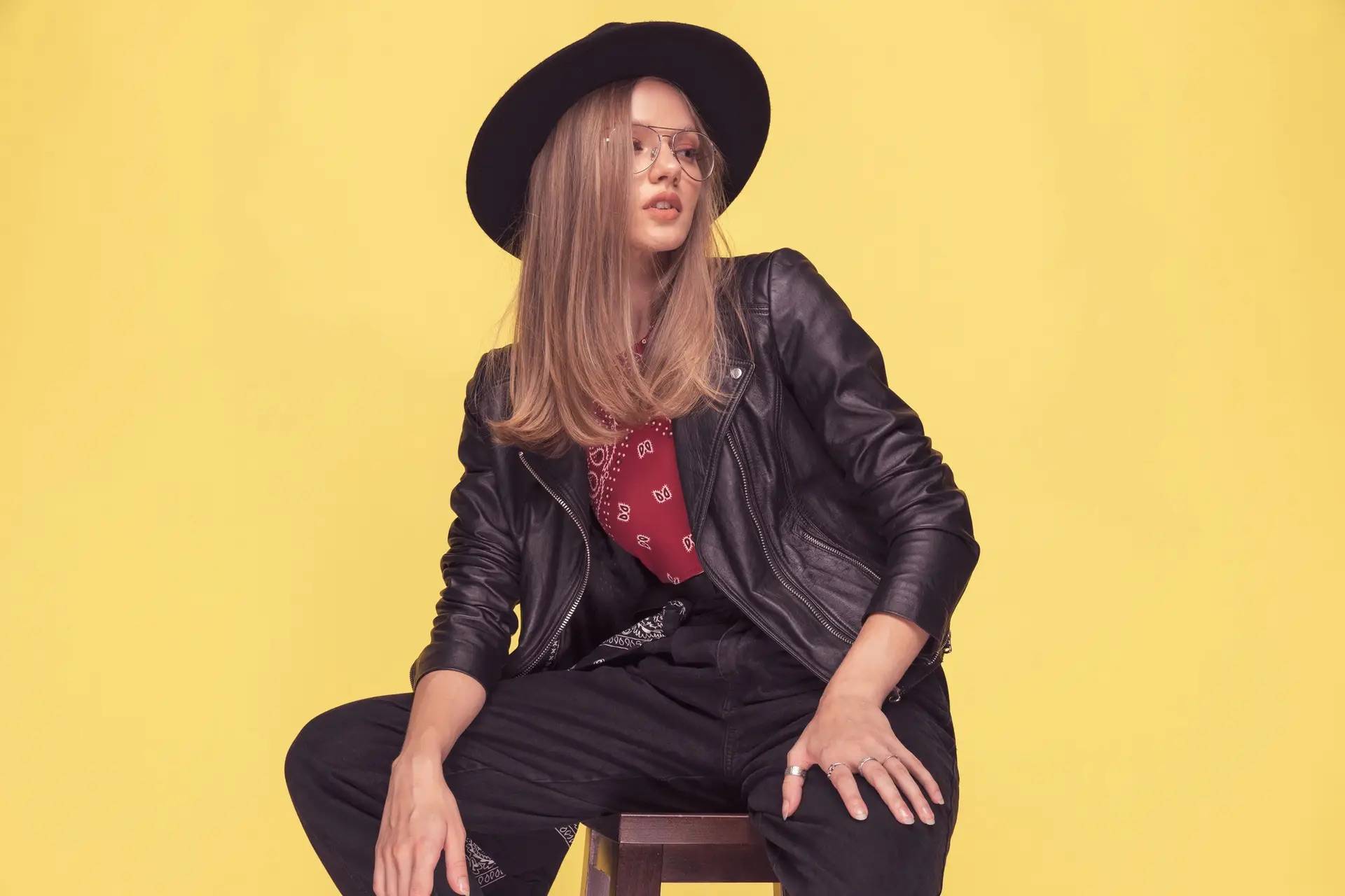 Woman wearing wide-brim hat and leather jacket