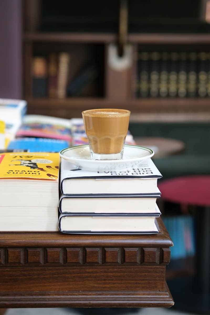 Coffee cup resting on stack of books