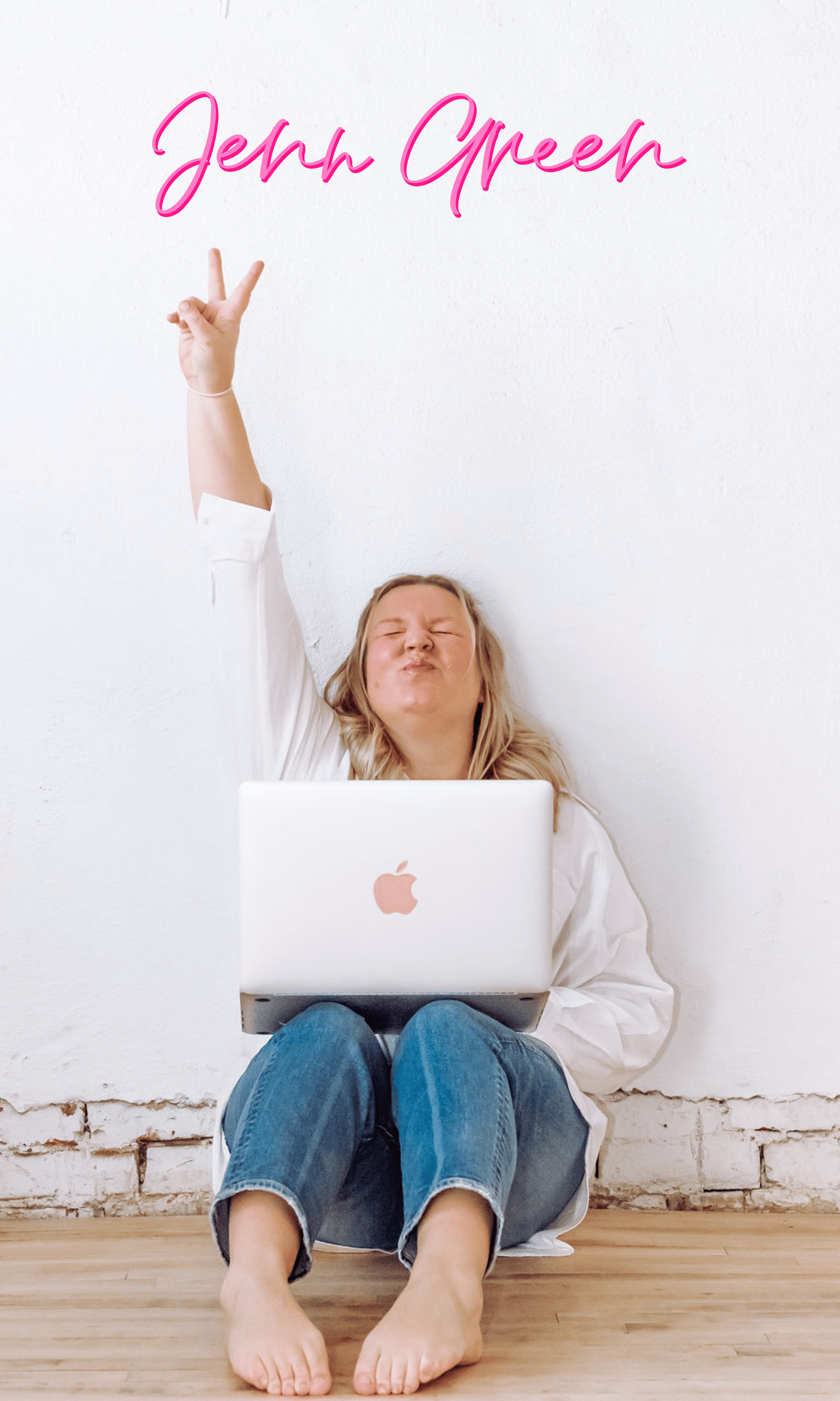 An image of Jenn Green sitting on the floor a laptop on her lap and her hand raised in the air.