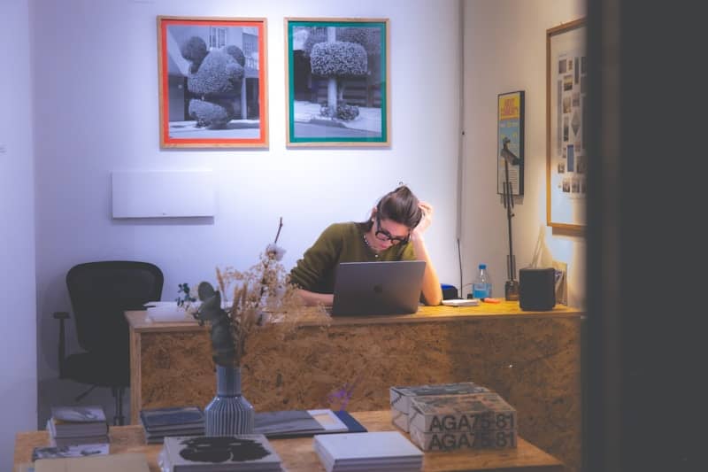A man sitting at a desk working on a laptop