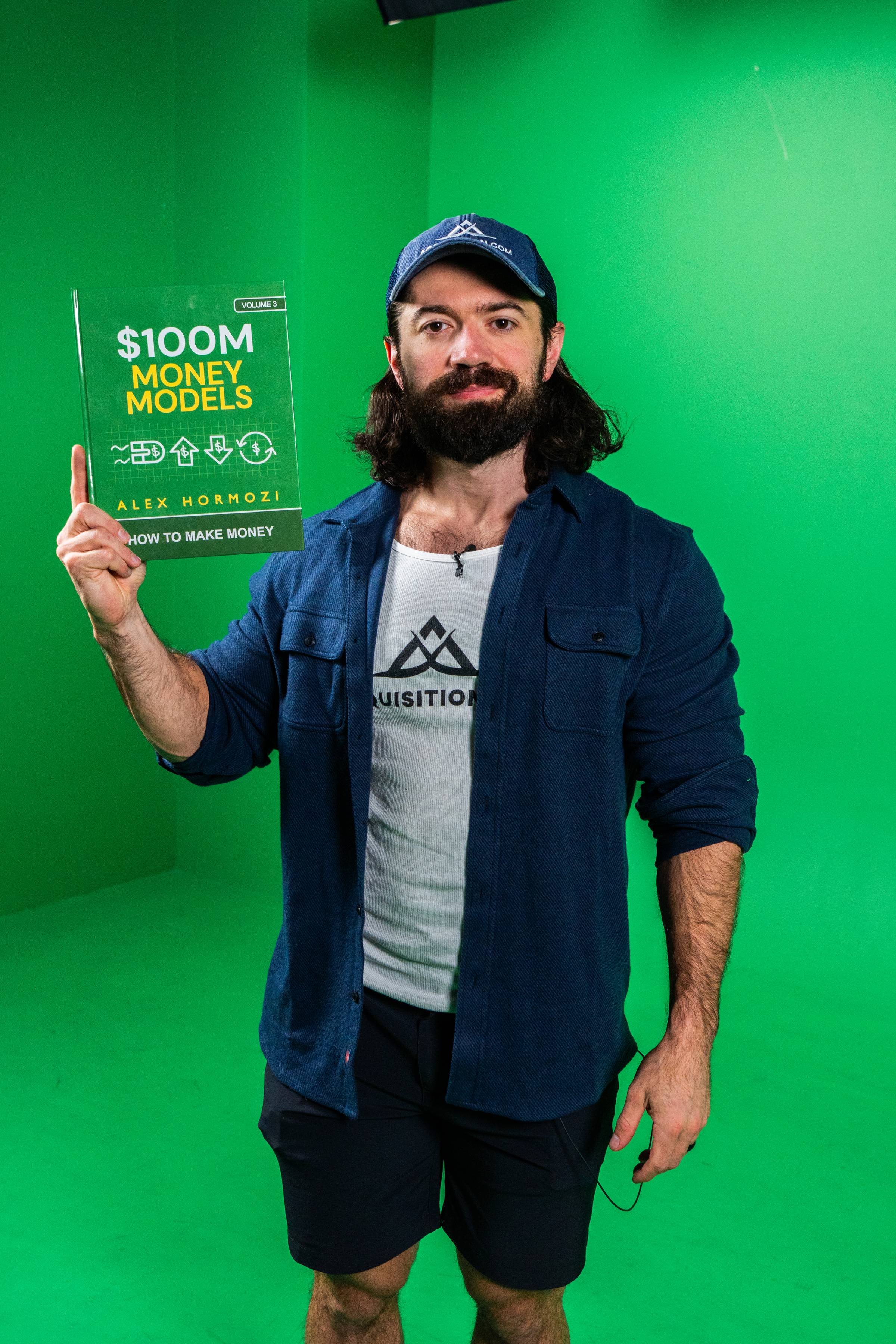 Alex Hormoze holding Money Models book
