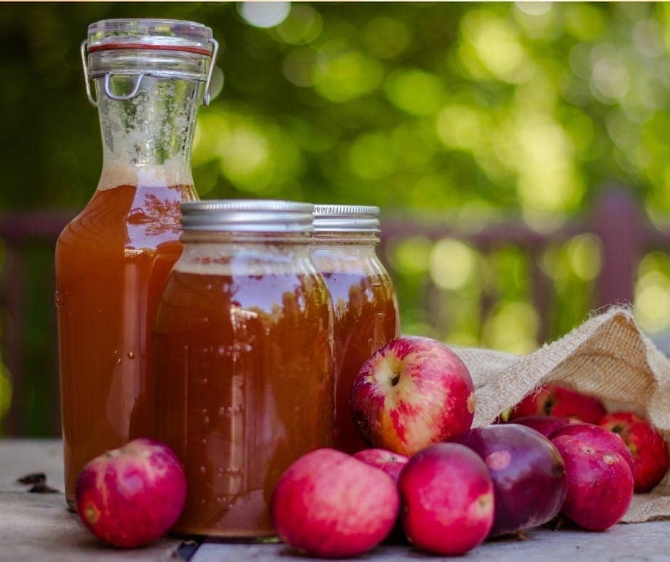 Apples and a carafe of Fresh Apple cider 