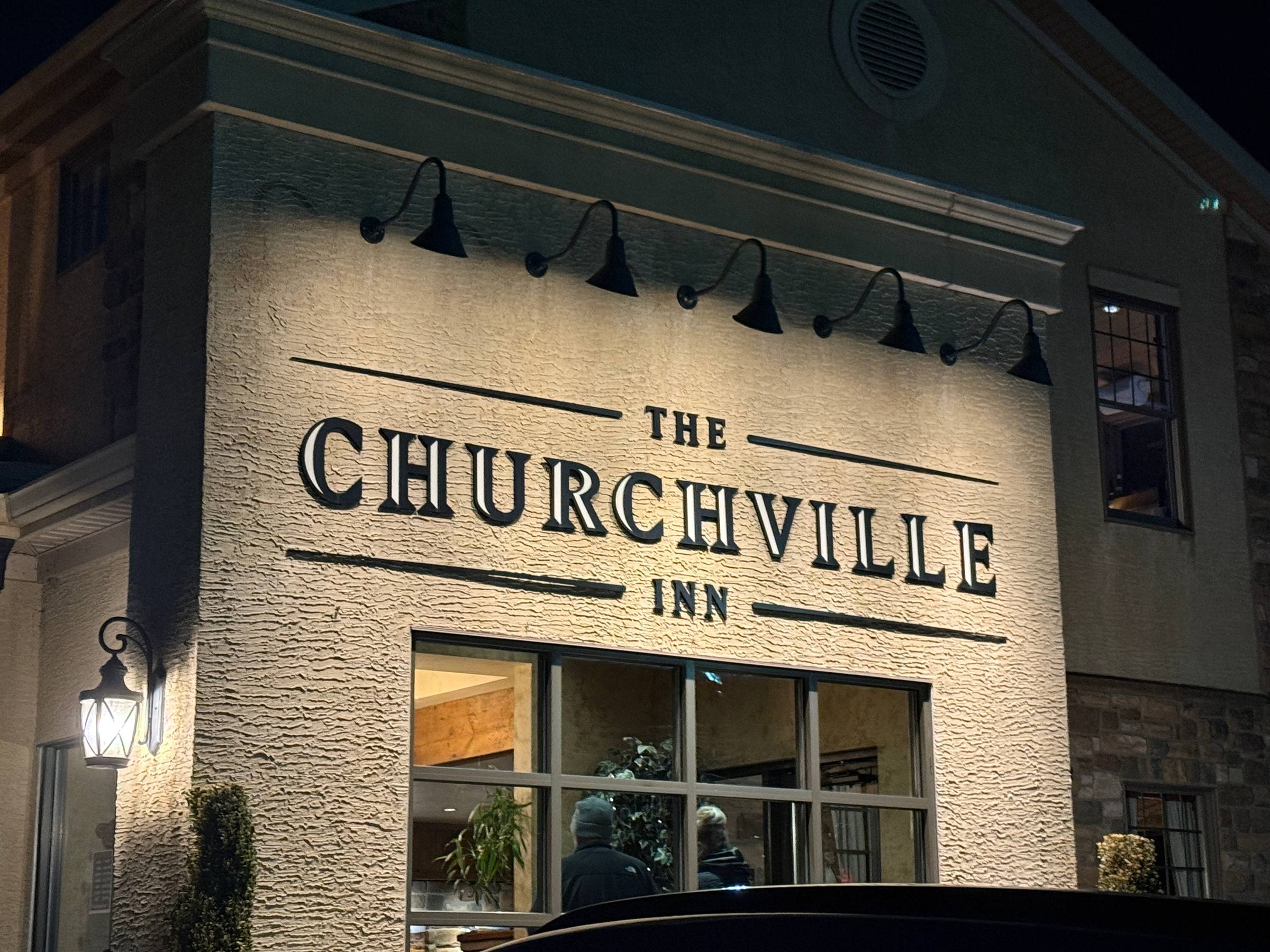 Churchville Inn restaurant exterior at night with illuminated signage