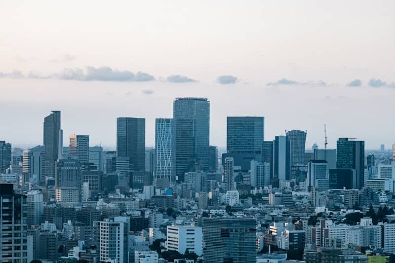Modern city skyline with tall buildings under a cloudy sky