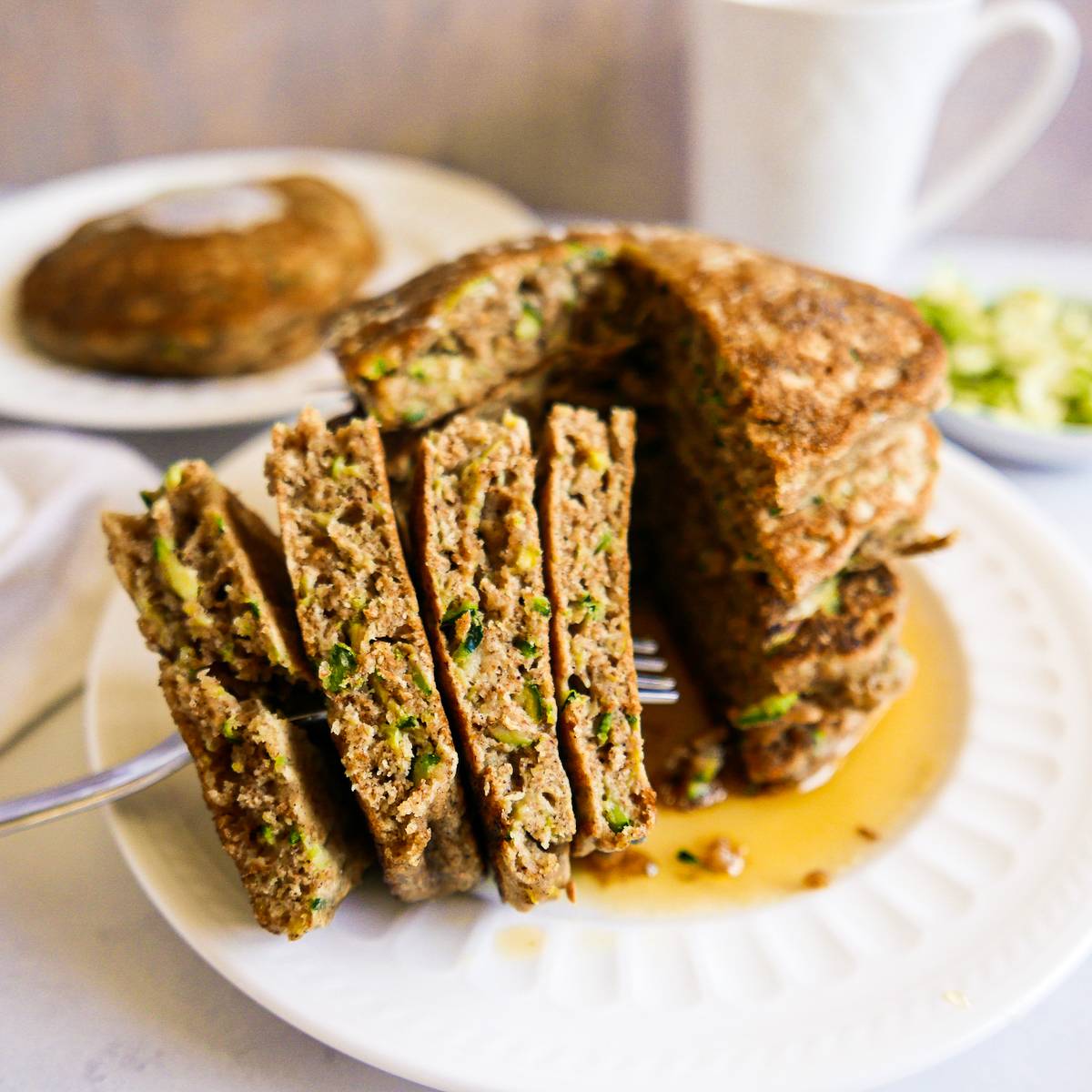 Zucchini pancakes cut onto a fork.