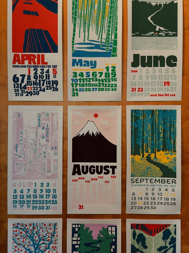 Calendar pages with artistic monthly illustrations.