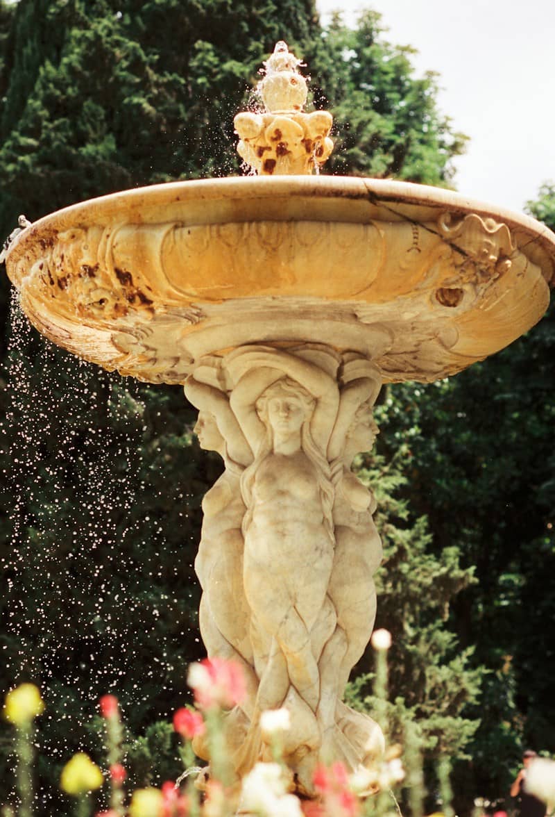 Stone fountain with figures and flowing water