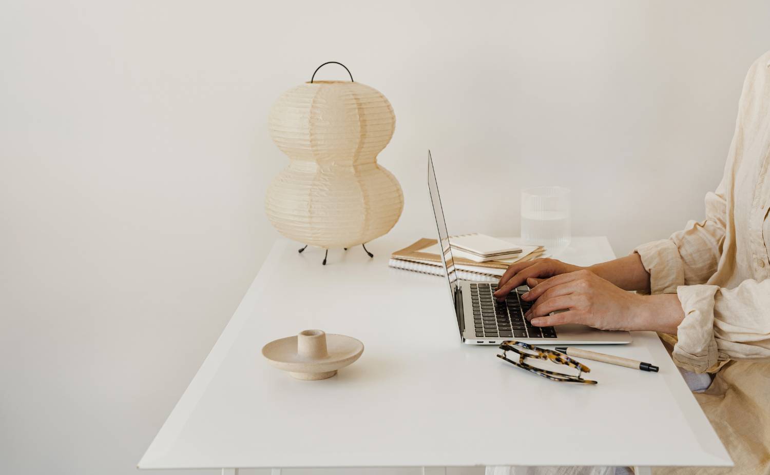 Beige Neutral Typing at Standing Desk with Beige Lamp