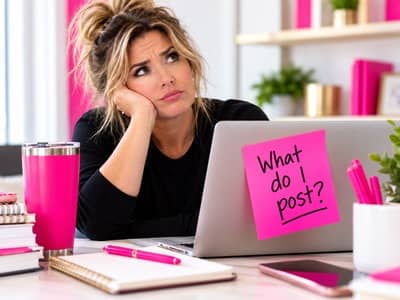 Small business owner staring at her laptop, wondering what to post on social media.