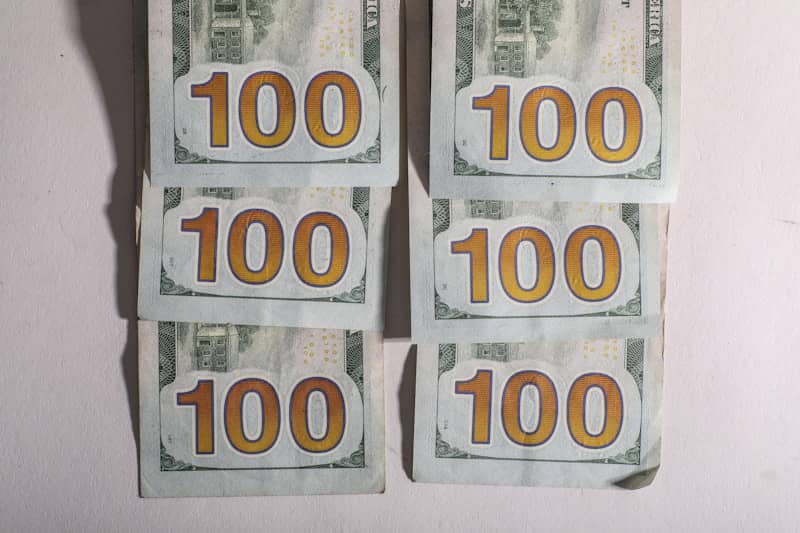 Six stacks of one hundred dollar bills