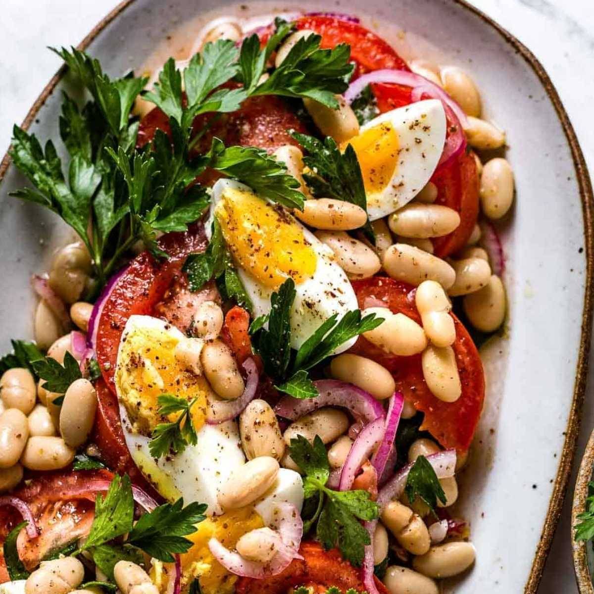 A plate of tomato white bean salad in a plate.