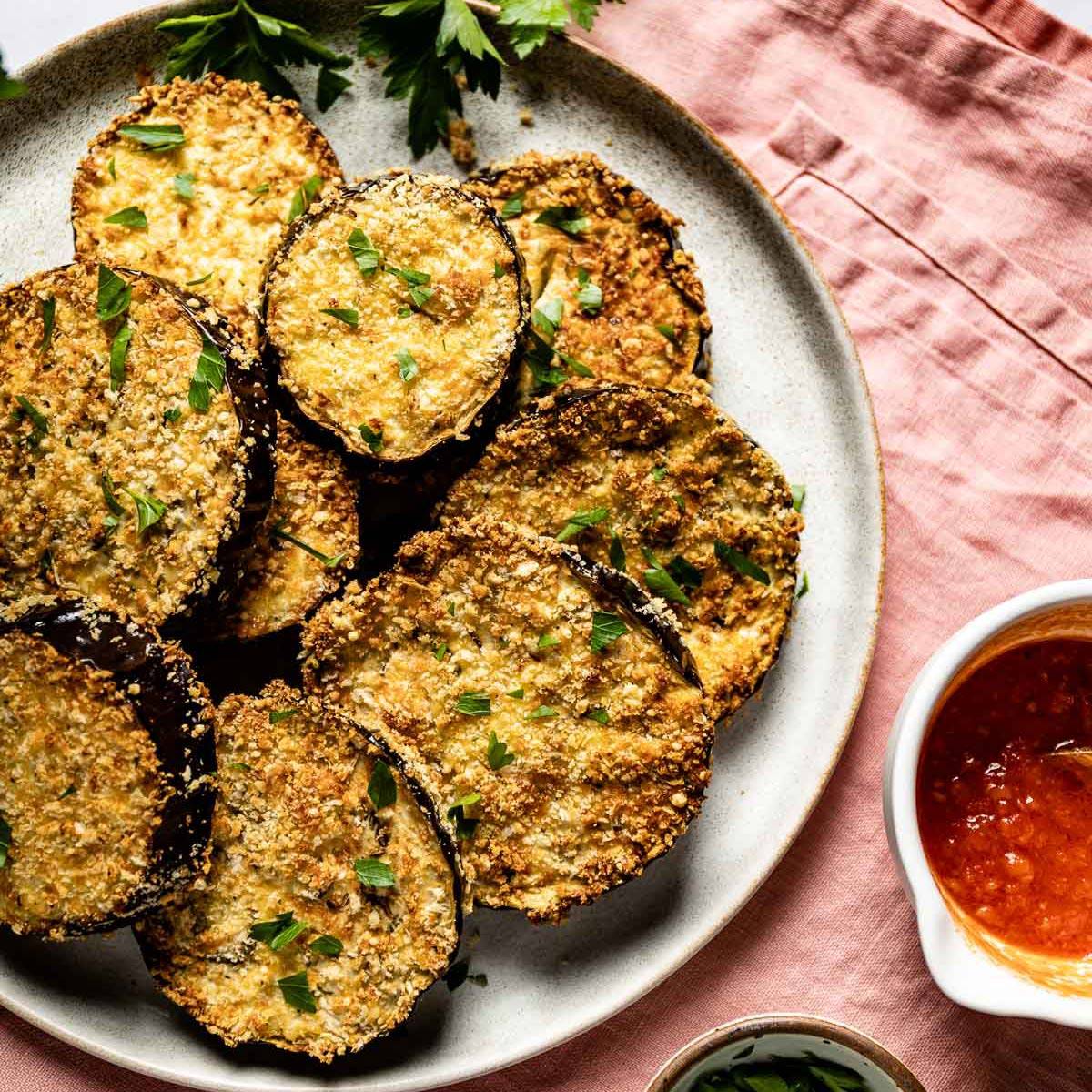 Breaded eggplant in air fryer with a sauce on the side