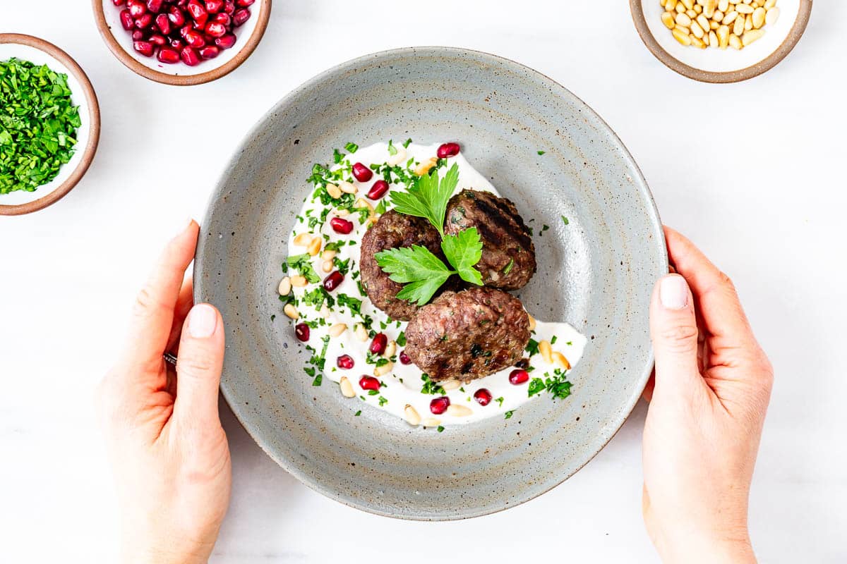 Turkish meatballs on a bed of yogurt sauce.