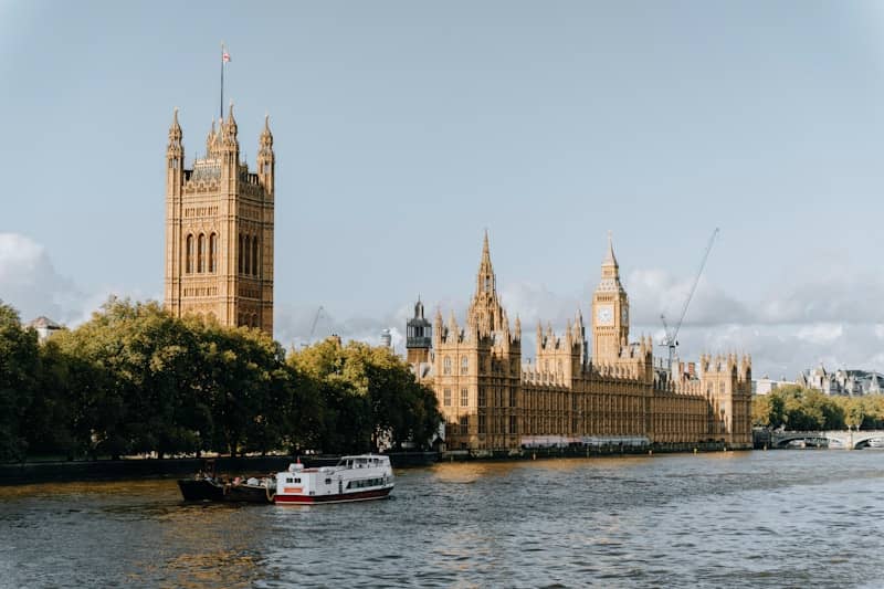 A river with a boat in it and a large building in the background