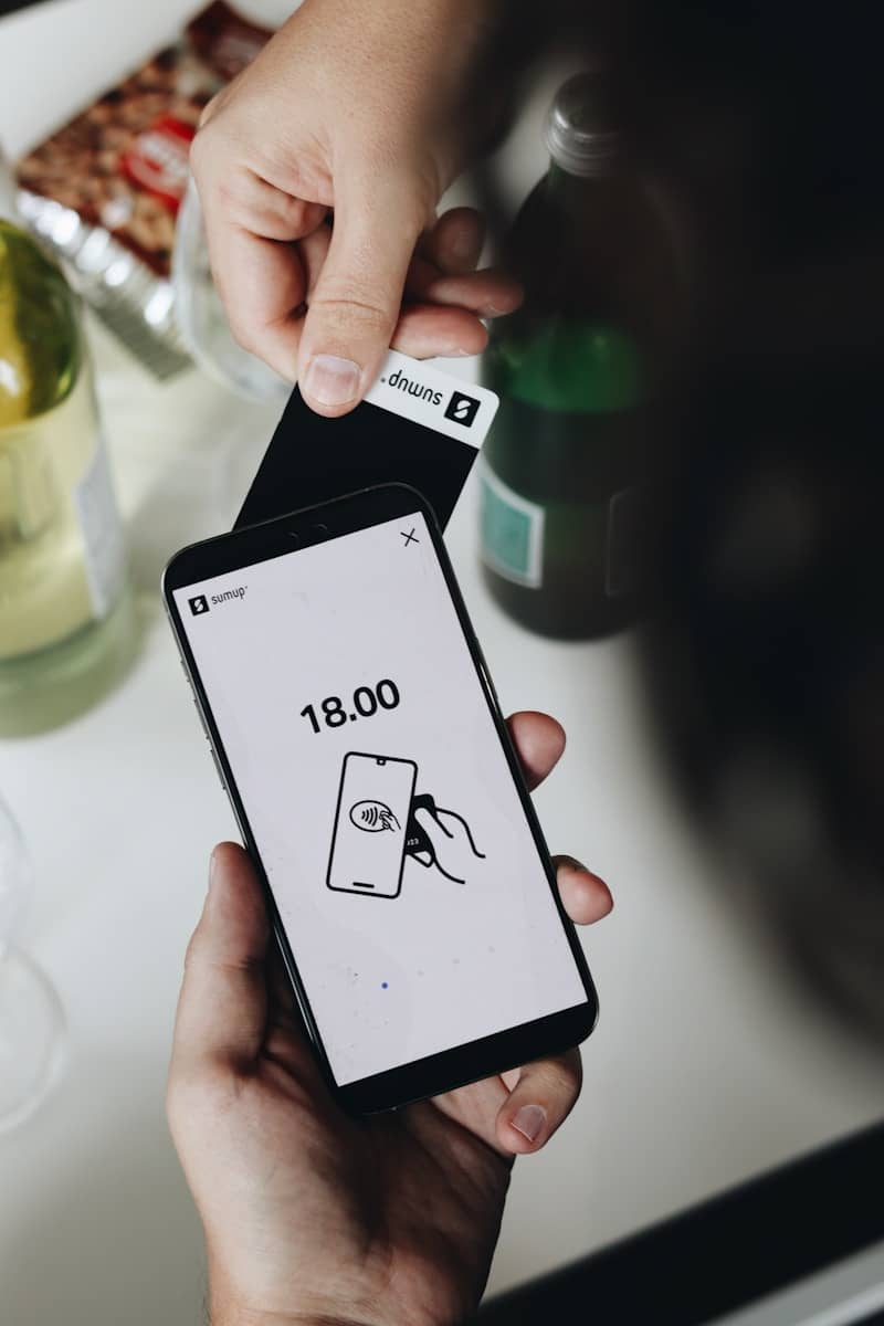 A person holding a smart phone in their hand