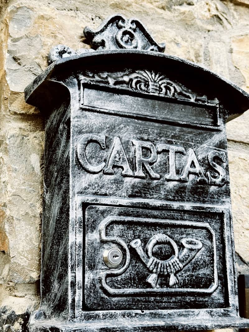 Ornate antique mailbox with 'cartas' inscription