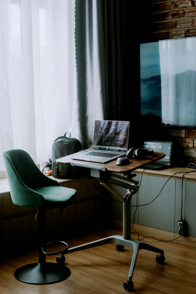 Modern home office setup with laptop and equipment.