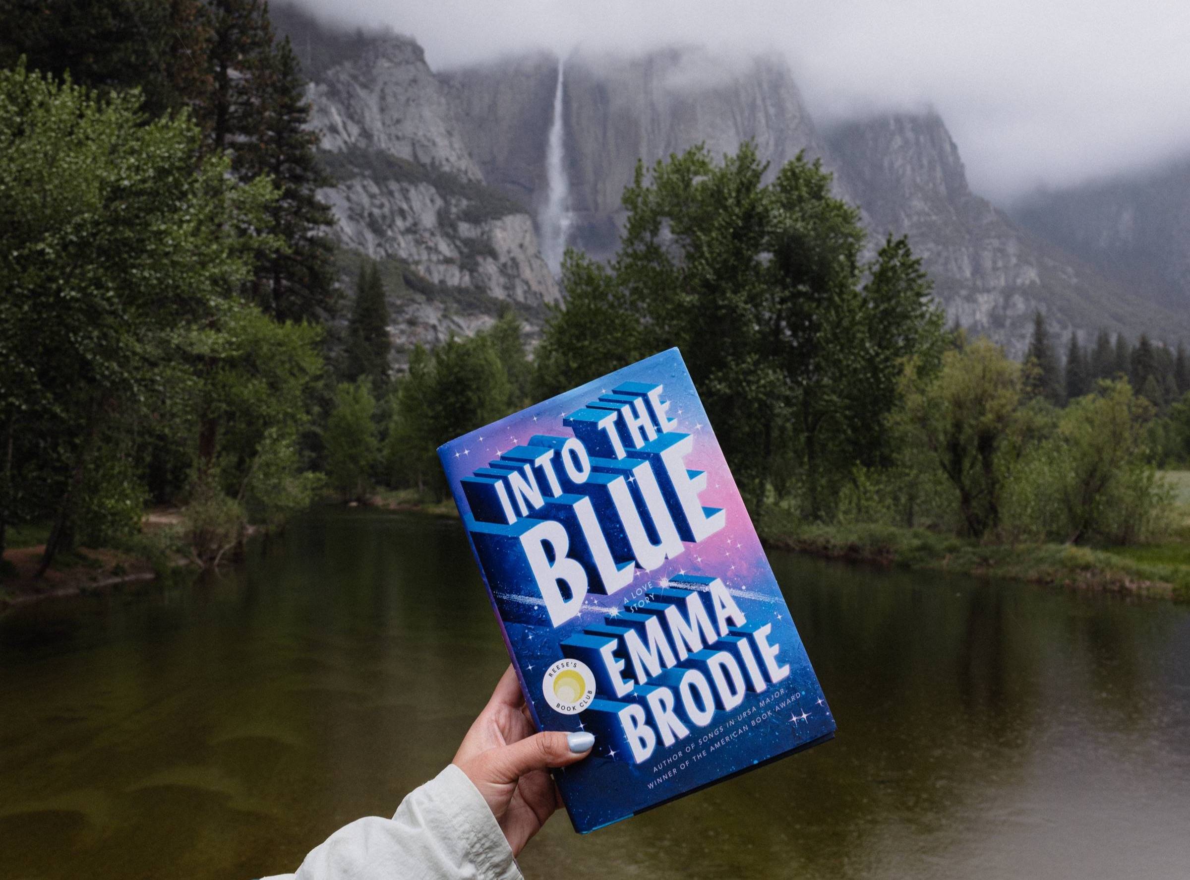 A copy of Into the Blue by Emma Brodie against Yosemite Falls
