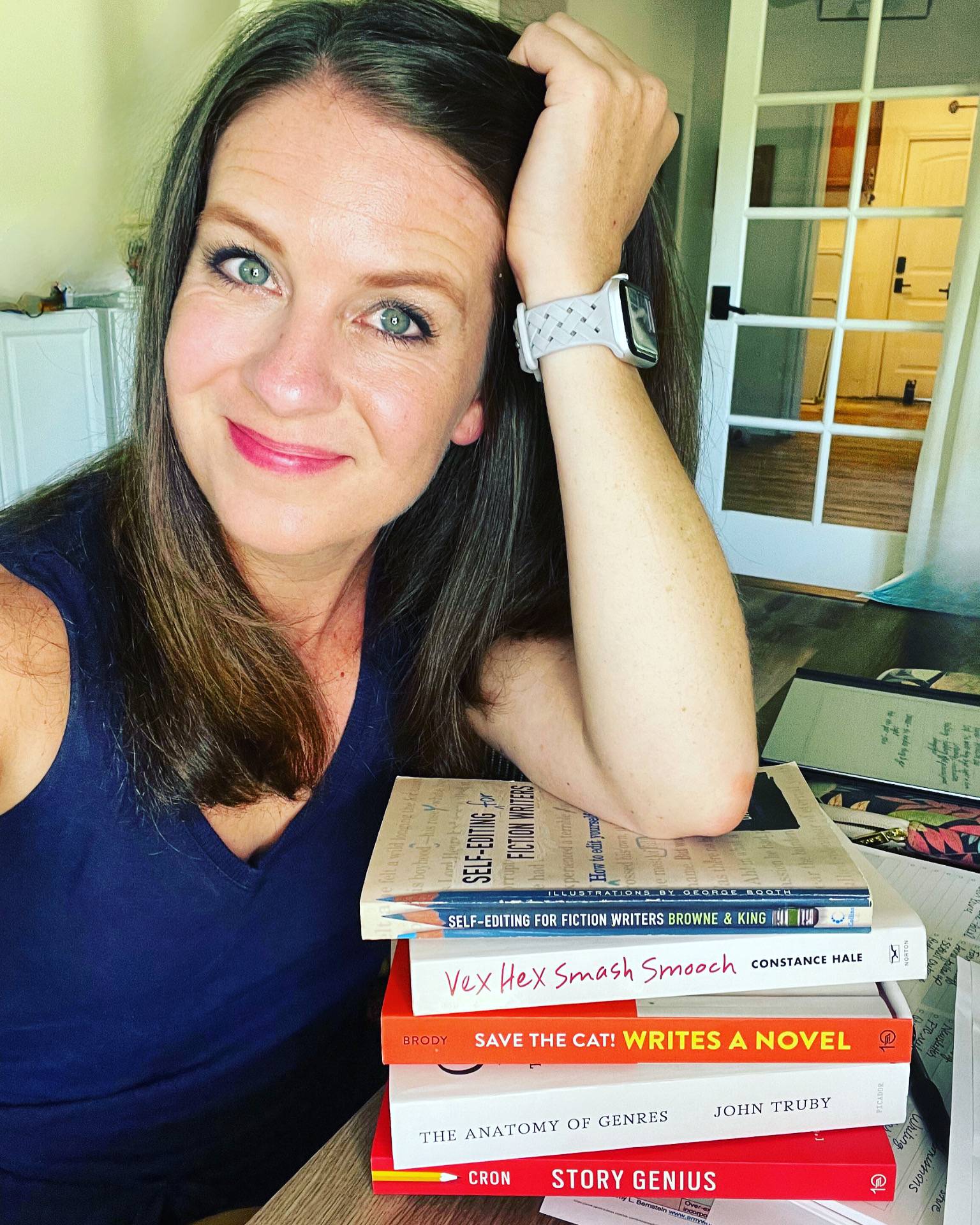 An image of Karyn Fischer leaning on writing books